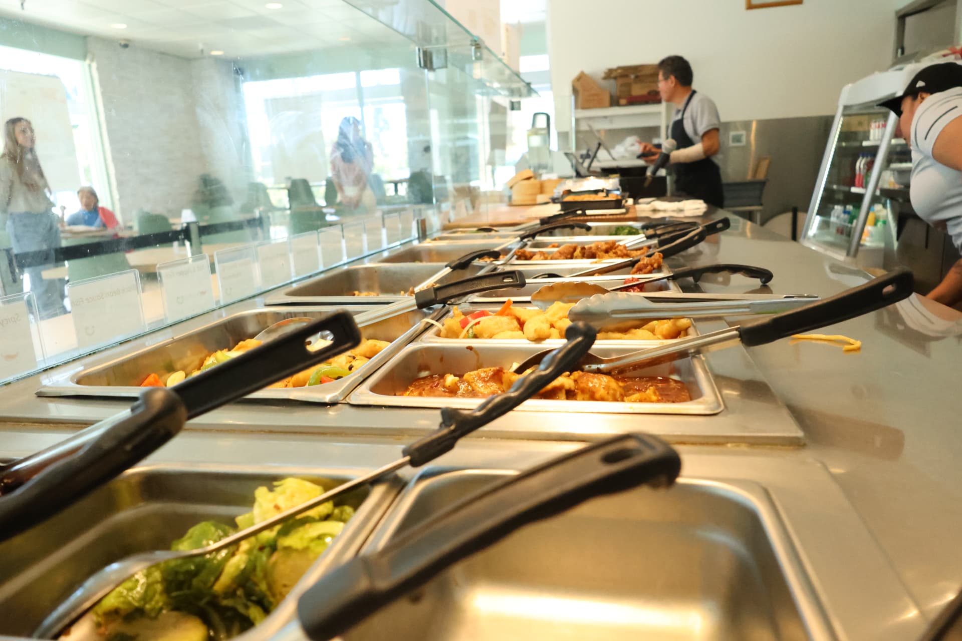 The Eaping serving line with hot-food pans and tongs during service